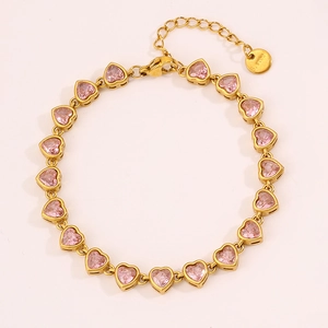Detailed macro view of pink heart-shaped crystals on a gold stainless steel chain