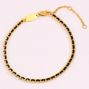 Detail of black woven rope bracelet with gold metal beads and adjustable lobster clasp