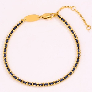 Detailed close-up of 18k gold plated chain braided with dark blue string and lobster clasp
