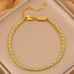 Detail of green woven cord bracelet with gold beads, lobster clasp and extension chain