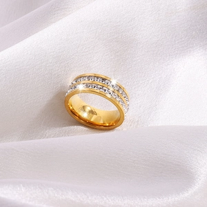 Luxury gold titanium steel double row zircon ring on elegant white silk background