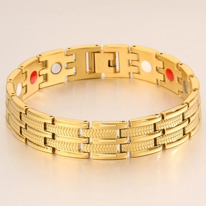 Detail of gold stainless steel bracelet with magnetic therapy inserts and clasp engraving