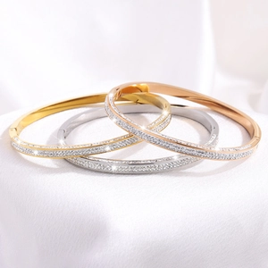 Detailed macro view of triple finish titanium steel bracelets with micro-pave diamond inlay
