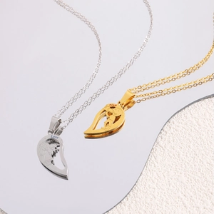 Macro shot of titanium steel split heart key necklaces with engraved Love You text