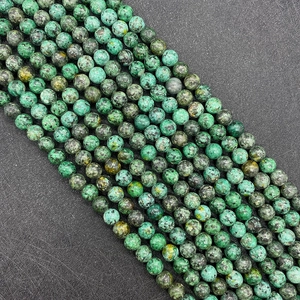 Macro detail of natural African turquoise round beads with unique green and black patterns