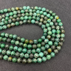 Macro shot of polished 6mm-10mm green African turquoise beads for jewelry DIY