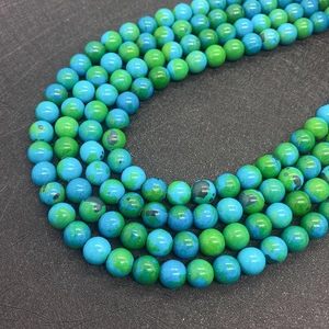 Macro view of blue and green phoenix stone round beads for DIY jewelry making