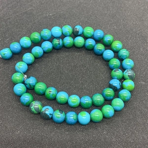 Macro shot of natural green phoenix stone beads with earth texture for jewelry making