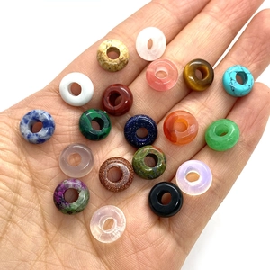 Assorted 4x10mm natural stone donut beads in hand for DIY necklace jewelry making