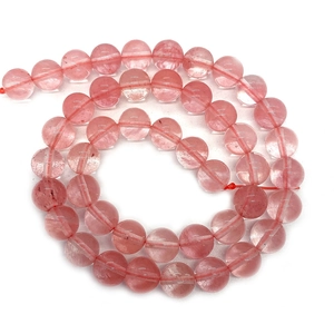 Pink natural strawberry quartz round beads for DIY jewelry making neatly arranged on white