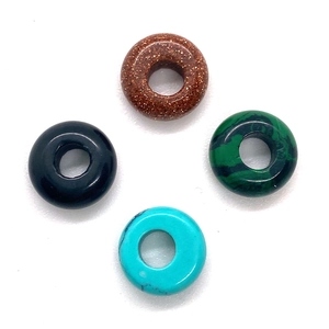 Polished natural stones including goldstone and malachite ring-shaped pendant beads