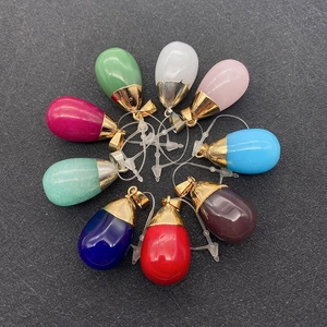 Top view of teardrop natural stone pendants in various vibrant colors with metal clasps