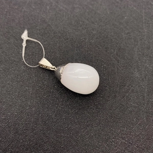 Detailed view of polished white teardrop gemstone pendant with silver bail connector