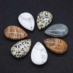 Macro detail of teardrop natural stone pendants with polished finish for DIY jewelry