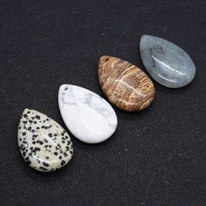 Detail view of teardrop natural stone pendants with pre-drilled holes for jewelry DIY