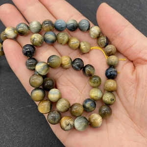 Detailed macro view of 9mm natural tiger eye stone beads in mixed colors for jewelry making