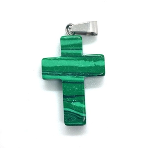 Macro shot of malachite cross pendant with green stripes and silver metal clasp