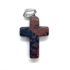 Macro detail of natural spotted stone cross pendant with silver metal bail on white background