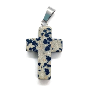 Detailed view of polished dalmatian jasper stone cross pendant with silver metal bail