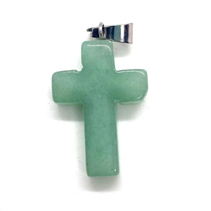 Macro shot of light green natural stone cross pendant with silver bail on white background