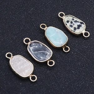 Macro view of natural stone connectors with gold edges for DIY jewelry making