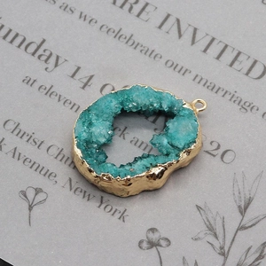 Macro detail of natural druzy stone pendant with gold plating for DIY jewelry making