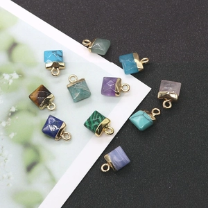 Macro view of faceted gemstone pendants with gold plated edges in various natural colors