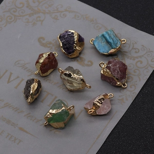 Detailed view of irregular natural stone connectors with gold plated edges and double rings