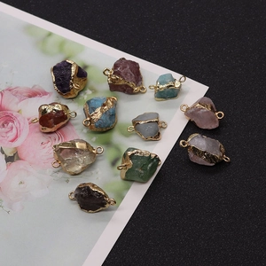 Detail of assorted irregular raw stones with gold plating and dual connectors for DIY jewelry