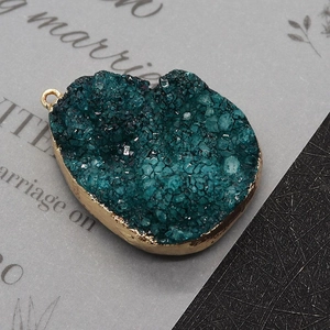 Macro shot of heart-shaped blue druzy crystal pendant with gold plating for DIY jewelry
