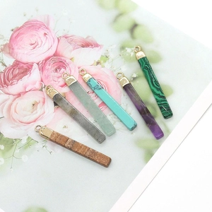 Selection of natural stone rectangle pendants with gold clasp on floral background