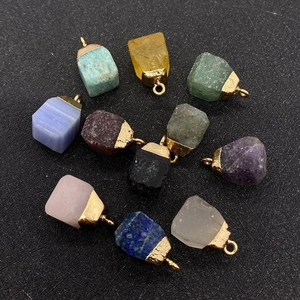 Flat lay of ten natural raw stone pendants with gold metal caps for DIY jewelry making