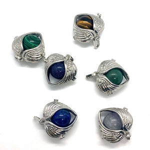 Angel wing cage pendants set with various gemstones like tiger eye and lapis lazuli