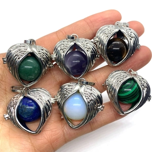 Natural gemstone sphere pendants with silver wing wrap in various colors like lapis lazuli