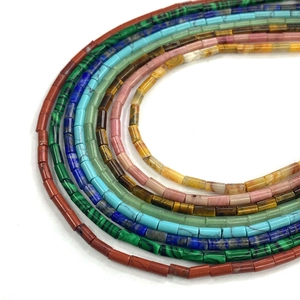 Macro view of multi-color cylindrical stone beads with natural polished mineral textures
