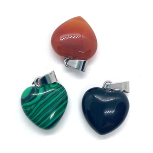 Three heart-shaped natural gemstone pendants with silver clasps on a white background