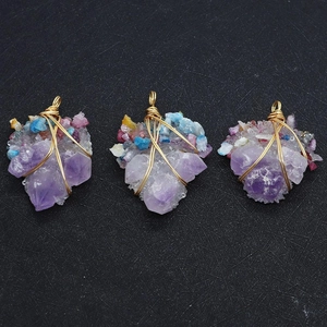 Detailaufnahme von handgefertigten Amethyst-Anhängern mit bunten Steinen und Drahtwicklung