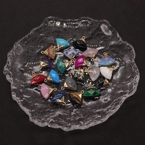 Macro shot of assorted colorful triangular gemstone pendants with gold hanging loops