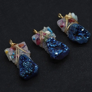 Detailed macro view of handmade blue natural crystal stone pendants with gold wire wrapping