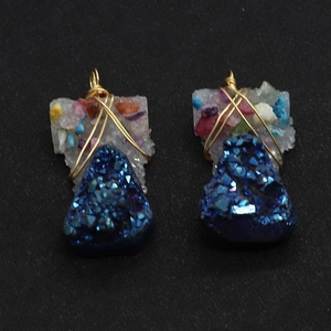 Detail view of handmade gold wire wrapped irregular blue crystal stone pendants