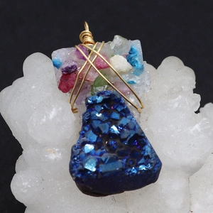 Irregular blue crystal natural stone pendant with gold wire wrap on white quartz