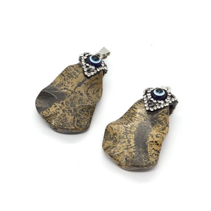 Irregular natural stone pendant with evil eye bead and rhinestone silver bail
