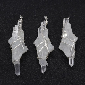 Tres colgantes de cristal blanco irregular con alambre de plata sobre fondo negro