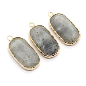 Three oval natural stone pendants with gold plated edges and grey spotted mineral texture