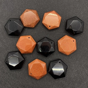Macro detail of faceted hexagonal pendants showing pre-drilled holes for DIY jewelry making