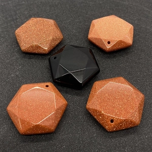 Macro shot of 28x28mm hexagonal natural stone pendants with faceted gold sand and onyx