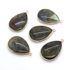 Teardrop labradorite gemstone pendants with gold edges and blue flashes in a set of five