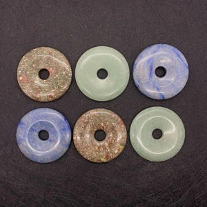Assorted natural stone donut pendants including green aventurine and blue mineral stones