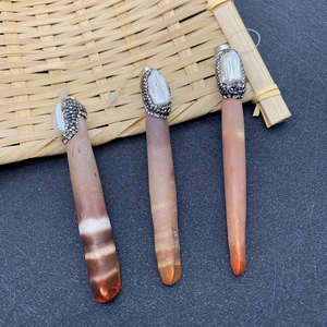 Natural brown shell pendant with baroque pearl and rhinestones on bamboo mat