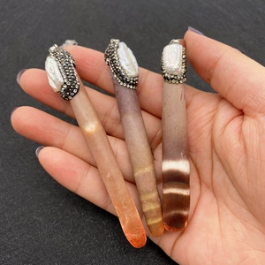 Three cylindrical gemstone pendants with baroque pearls and pave diamond settings